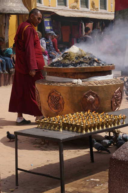 The pungent sweet smell of incense fills the air